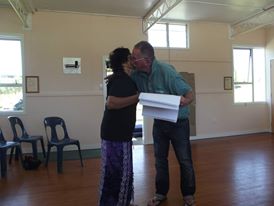 Dr Terry Ryan giving a copy of the Whakapapa to Erena Rigby.