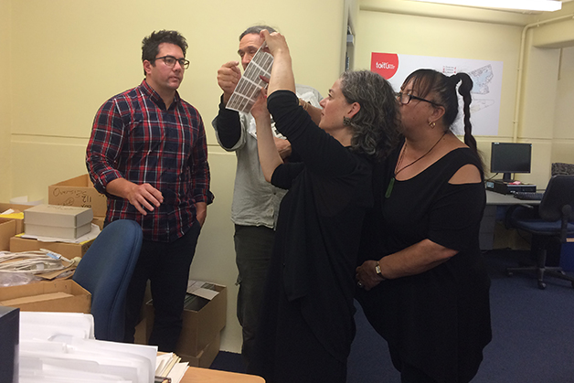 Ngāi Tahu Archive Team visit with Bill Dacker. Left to right: Takerei Norton, Bill Dacker, Helen Brown and Robyn Walsh look at a sleeve of negatives from the Bill Dacker photograph collection.
