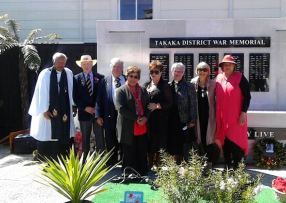 Richard and Mere pictured with local kaumātua in front of the memorial wall.