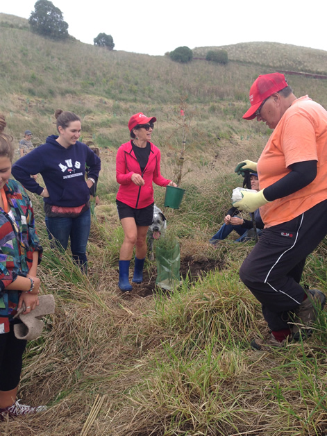 Volunteers join the local community in planting natives at Huriawa pā.