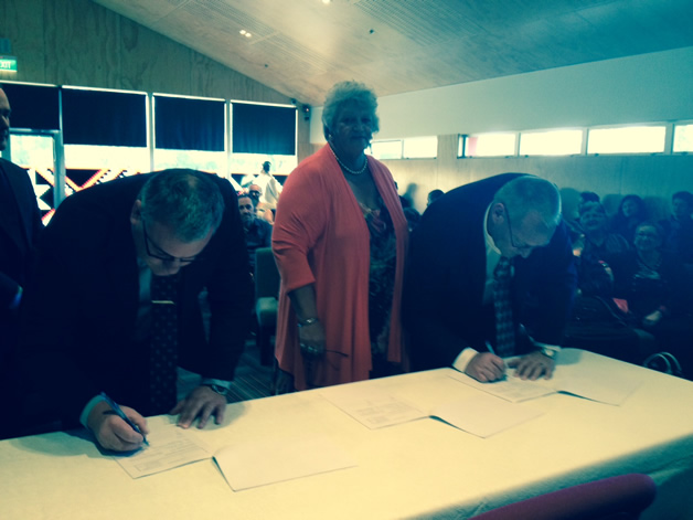 Warwick Isaacs of CCDU with Clare Williams and Tā Mark Solomon sign the Heads of Agreement.