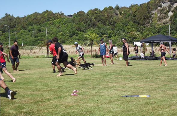 Whānau playing a game of touch.