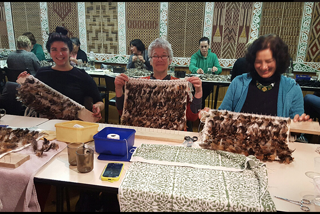 From left, Terina Stockwell, Louise Fowler and Eve Fowler-Stockwell working on their short korowai weaving. 